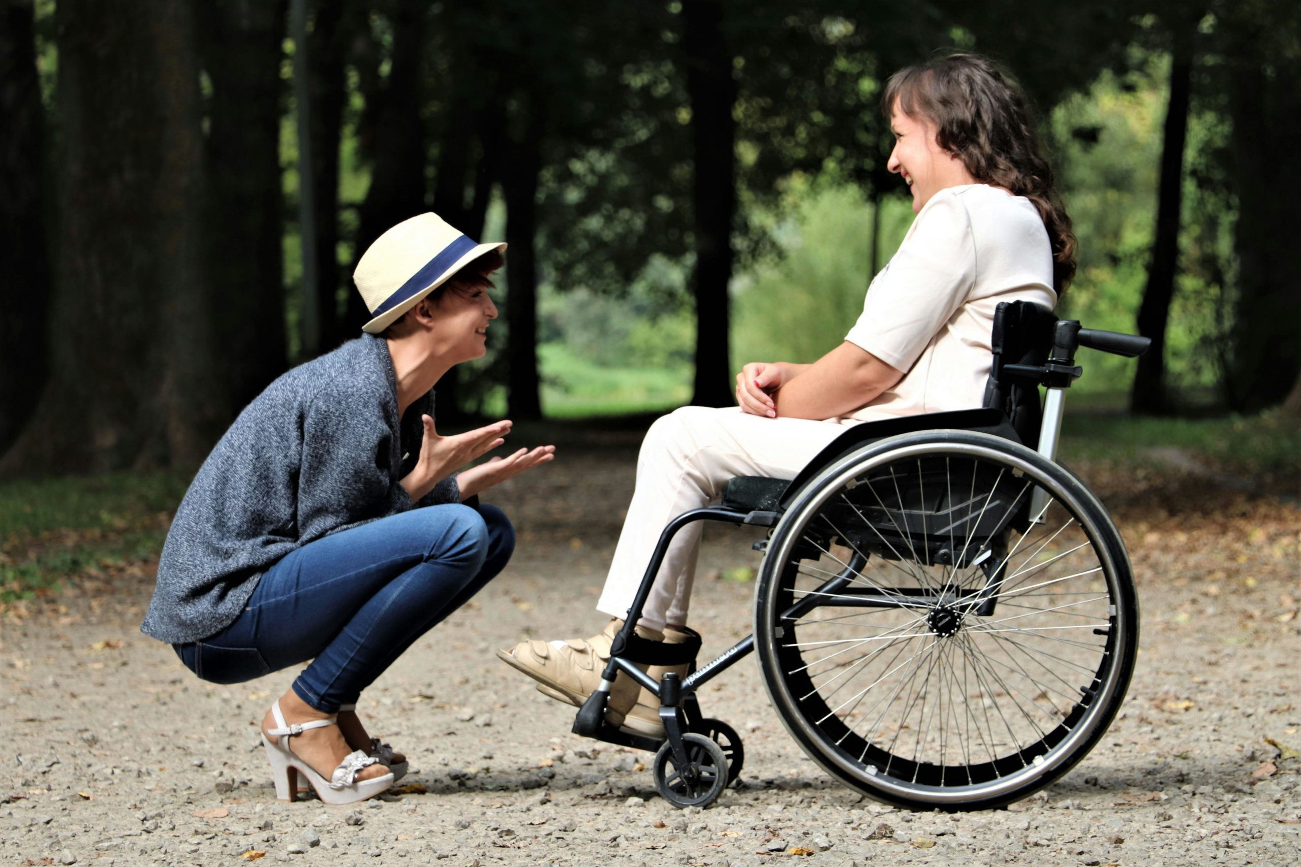Woman speaking to person in wheelchair